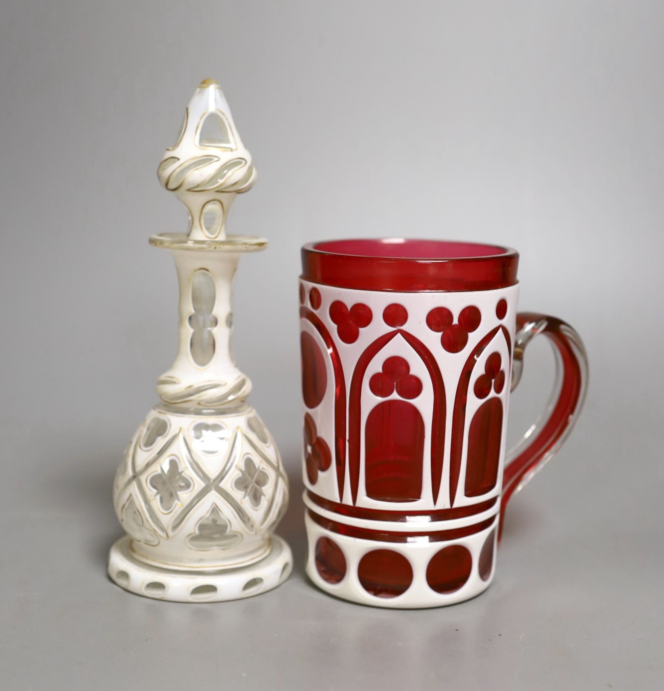 A Bohemian cranberry overlay mug and similar white overlay scent bottle, Scent bottle 17 cms high.